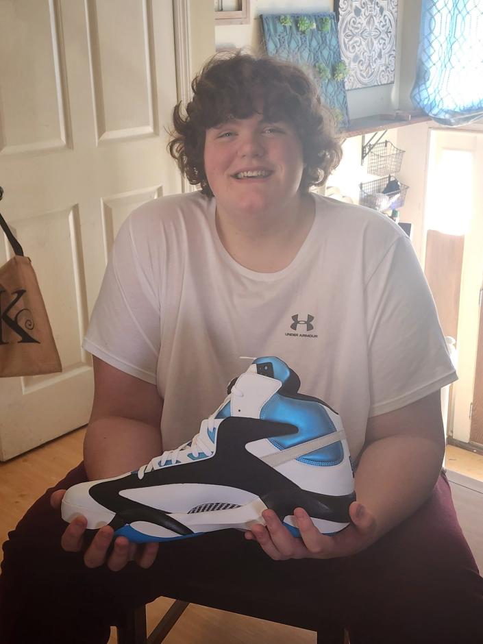 Eric Kilburn wearing shoes made by Reebok for Shaquille O'Neal, but gifted to the 14-year-old who has struggled to find shoes that fit.