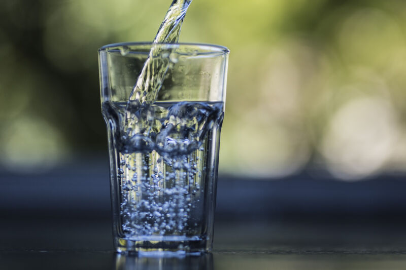 A glass is filled with drinking water.