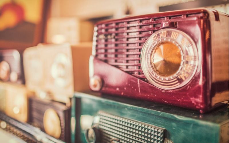 Stack of old colorful radios in the sunlight 