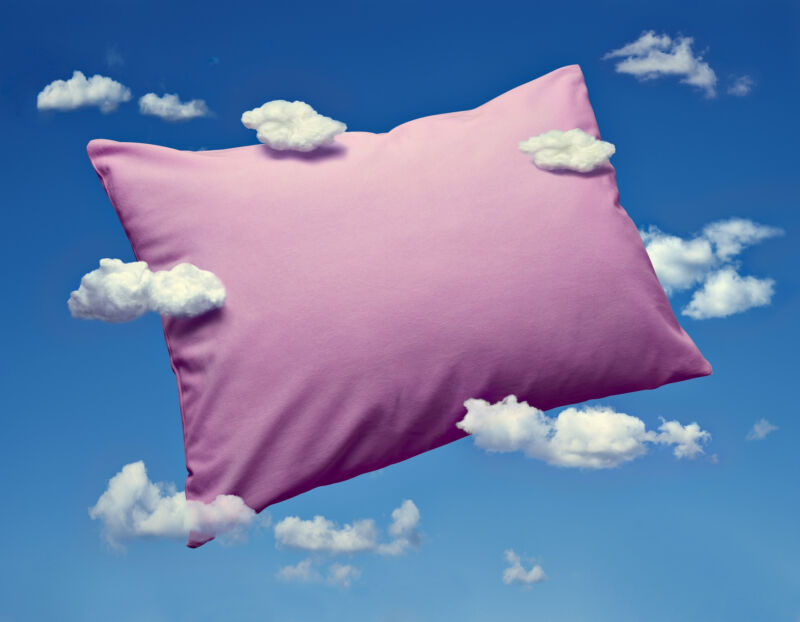 Picture of a pillow surrounded by clouds.