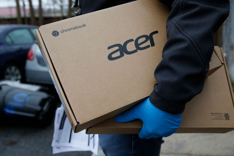 Man with two Acer laptop boxes