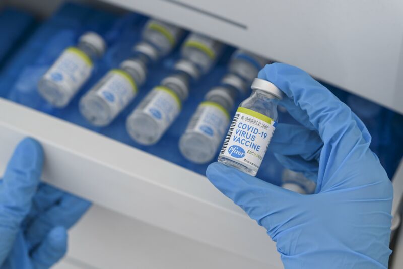 Vials of COVID-19 vaccine labels with logos of pharmaceutical company Pfizer and German biotechnology company BioNTech.