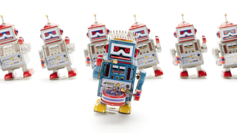 Tin robots dancing in a stock photo.