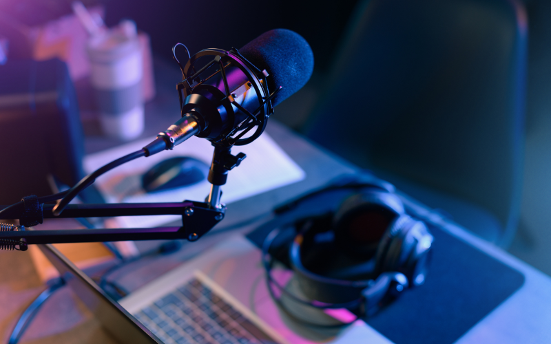 Radio station microphone and mouse with purple light and coffee cup