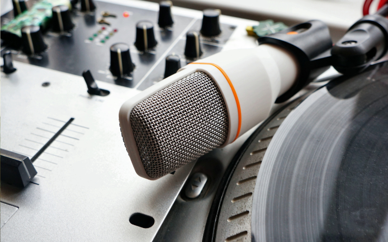 Microphone, radio switch and CD close-up playing British hip-hop