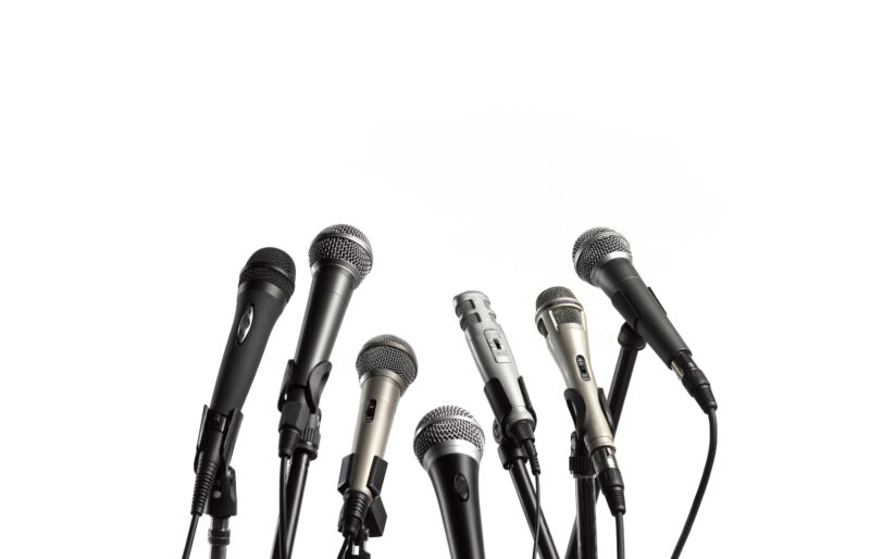 CLOSE-UP OF THE PRESS CONFERENCE MICROPHONES