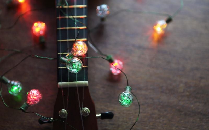 Guitar with Christmas lights placed over it 