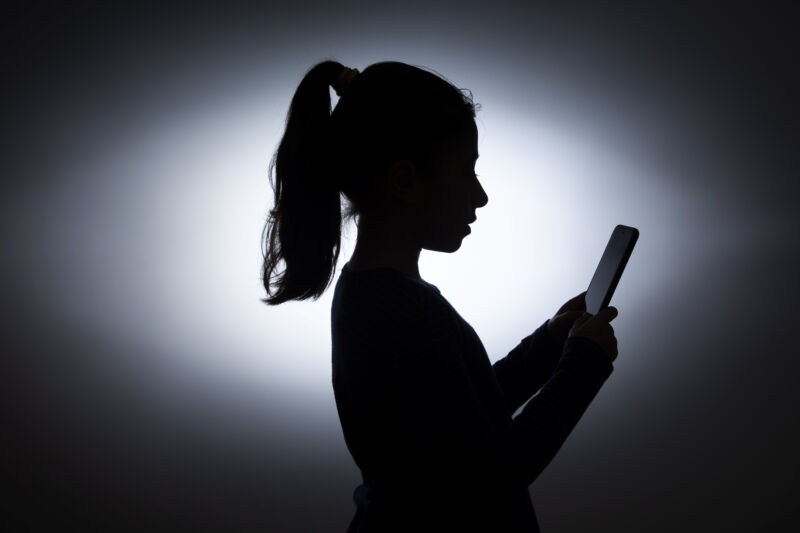 silhouette of a little girl with a phone