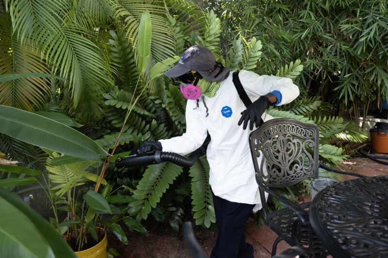 A Miami-Dade mosquito control inspector sprays a pesticide to kill adult mosquitoes on June 29, 2023 in Miami.  Miami-Dade's mosquito control department continues to regularly spray and inspect neighborhoods and is ready to respond if malaria mosquitoes are found, such as in the Sarasota area.