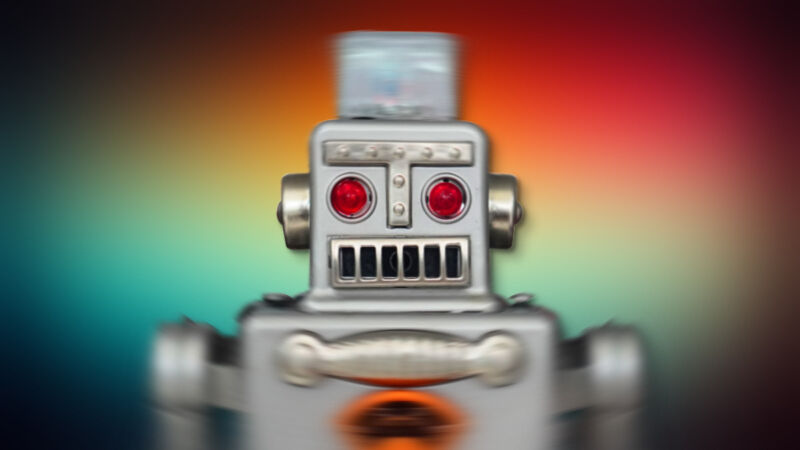 A shaky toy robot on a multicolored background.