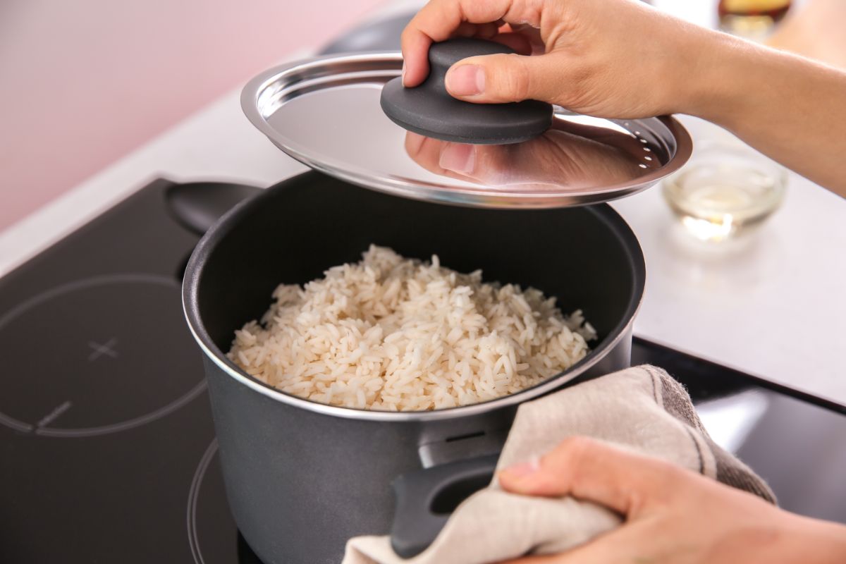 Woman Cooking Rice in Kitchen